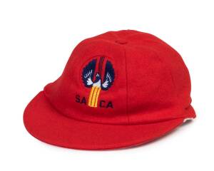 SOUTH AUSTRALIAN CRICKET CAP, from 1986-87, baggy red with embroidered "SACA" badge on front. Good condition. 