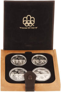 1976 (Krause.MS1-7) Montreal Olympics cased sets of 4 sterling silver coins, 2 x $5.00 & 2 x $10.00. 7 individual sets issued 1973 to 1976. We calculate 30.35oz ASW. All in original packaging with a display stand.