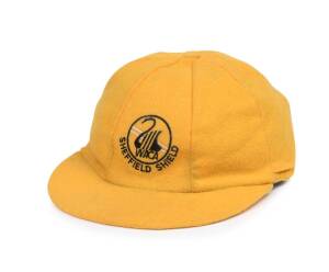 GRAEME WOOD'S WEST AUSTRALIAN CRICKET CAP, yellow, with embroidered "WACA/ Sheffield Shield" logo on front, named inside "Wood". Good match-worn condition. [Graeme Wood played 59 Tests & 83 ODIs 1978-89].