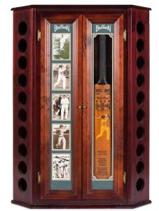 DON BRADMAN WINE CABINET, corner unit, 120cm tall & 86cm wide, with storage for 20 bottles of wine, decorated with 5 photos of Don Bradman (one signed) & replica "Sykes - Don Bradman" Cricket Bat engraved with Bradman's record. 