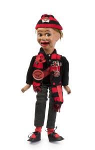 GERRY GEE FOOTBALL SUPPORTER - ESSENDON: Rare "Gerry Gee Junior" ventriloquist doll dressed as an Essendon supporter, made by Lionel Sterne c1960. With later knitted cap & scarf added, decorated with Tarax Club & Essendon badges.