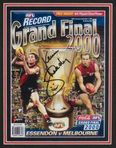 ESSENDON: Front cover of 2000 Grand Final "Football Record", Essendon v Melbourne, signed by Kevin Sheedy, window mounted, framed & glazed, overall 33x42cm. Ex James Hird collection. 