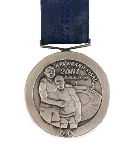 JAMES HIRD'S 2001 RUNNERS-UP MEDAL, from 2001 Grand Final, pewter medal showing two players with MCG in background, and text "AFL Grand Final, 2001, Runners-up/ AFL". Reverse has text, "To reach the Grand Final, the ultimate event in a long, arduous, and 