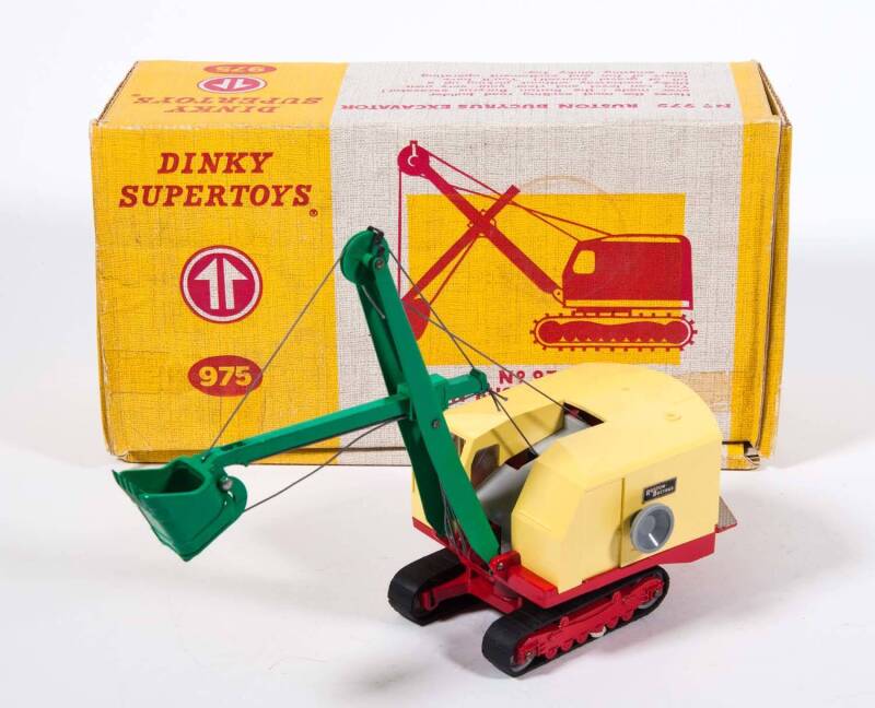 DINKY: 1960s Ruston Bucyrus Excavator (975). Mint in original yellow hinge lidded cardboard box with original instructions and correct inner packing pieces. Slight damage to parts of the box. 
