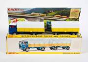 DINKY: Early 1970s Mercedes-Benz Truck and Trailer (917) – Blue Cab with Yellow Trailer and White Plastic Canopies. Mint in original yellow cardboard pictured box.