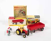 DINKY: Late 1960s to Early 1970s Group of Farm Vehicles and Trailers Including David Brown Tractor (305) &ndash; Red and Yellow; And, Disc Harrow (322) &ndash; White and Red; And, Large Trailer (428) &ndash; Red. All mint in original yellow cardboard pictured box. (3 items