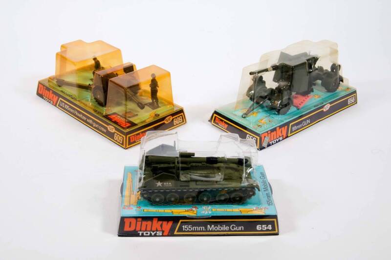 DINKY: 1970s Group of Military Land Based Vehicles Including U.S. 105mm Howitzer Gun with Crew (609); And, Leopard Tank (692); And, 155mm Mobile Gun (654); And, Striker Anti-Tank Vehicle (691). All vehicles mint in original bubble packs. Slight damage to