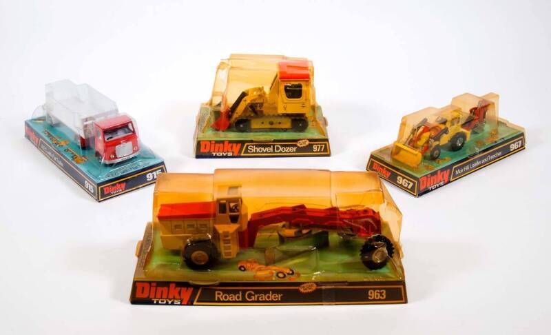 DINKY: 1970s Group of Construction Vehicles Including Shovel Dozer (977); And, Muir Hill Loader and Trencher (967); And, Road Grader (963). All vehicles mint in original bubble packs. Slight damage to the plastic on some of the bubble packs (4 items) 