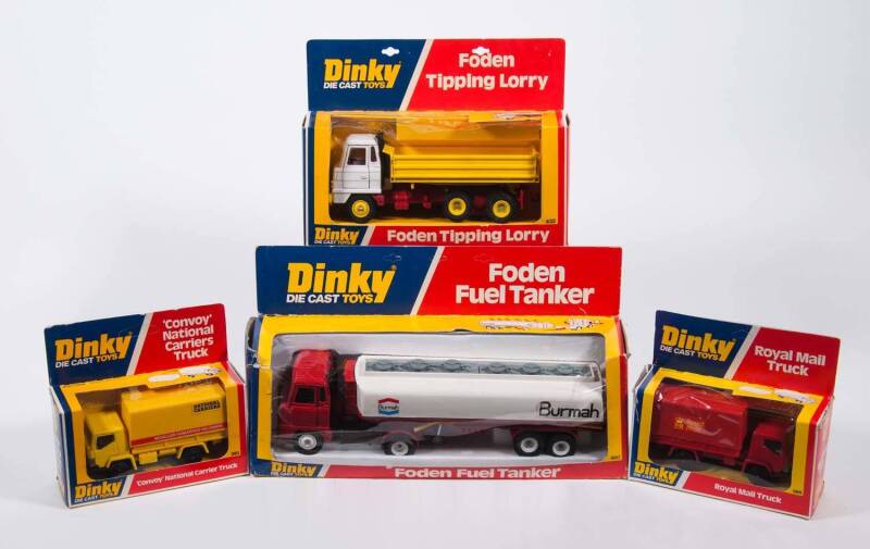 DINKY: Late 1970s Group of Commercial Trucks Including ‘Burmah’ Foden Fuel Tanker (950); And, Foden Tipping Lorry (432); And, ‘Convoy’ National Carrier Truck (383); And, Roil Mail Truck (385). All mint in original cardboard window boxes. Slight damage to