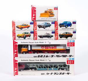 TOMICA: 1:43 Group of ‘Dandy’ Model Cars Including Mitsubishi Jeep J3R Fire Chief Car (42); And, Isuzu Elf Dump Truck (23); And, Hino Car Transporter (31). All mint in original cardboard packaging. (58 items)