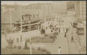 NSW: Sydney: ‘Circular Quay’ real photo postcard showing the Ferry Terminal and Tram Terminus, pedestrians and horse & cart traffic and advertising hoardings for ‘John Bridge and Co’ & ‘Wolfe's Schnapps’ in background, unused, fine condition.