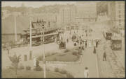 NSW: Sydney: ‘Circular Quay’ real photo postcard showing the Ferry Terminal and Tram Terminus, pedestrians and horse & cart traffic and advertising hoardings for ‘John Bridge and Co’ & ‘Wolfe's Schnapps’ in background, unused, fine condition.