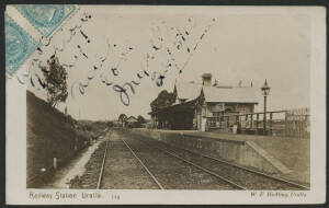 NSW: Uralla: ‘Railway Station, Uralla’ real photo postcard (published W.F Hickling, Uralla) showing Railway Lines & Station Platform, used to London with QV ½d green pair (folded over edge) tied Sydney 1910 roller cancel, otherwise fine condition.