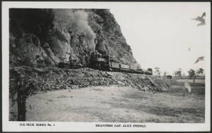 Northern Territory: Alice Springs: ‘Heavitree Gap, Alice Springs’ real photo postcard (DB Neck series No1 published by Valentines) showing Steam Locomotive & Goods Wagons rounding Escarpment, unused, fine condition.