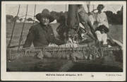 Northern Territory: Melville Island: ‘Melville Island Alligator [sic] NT’ postcard (F. Birtles photo) showing White Hunter with Crocodile on Boat alongside Group of Aboriginals, sent to Germany with message in German and South Australia QV 1d red tied ‘PT