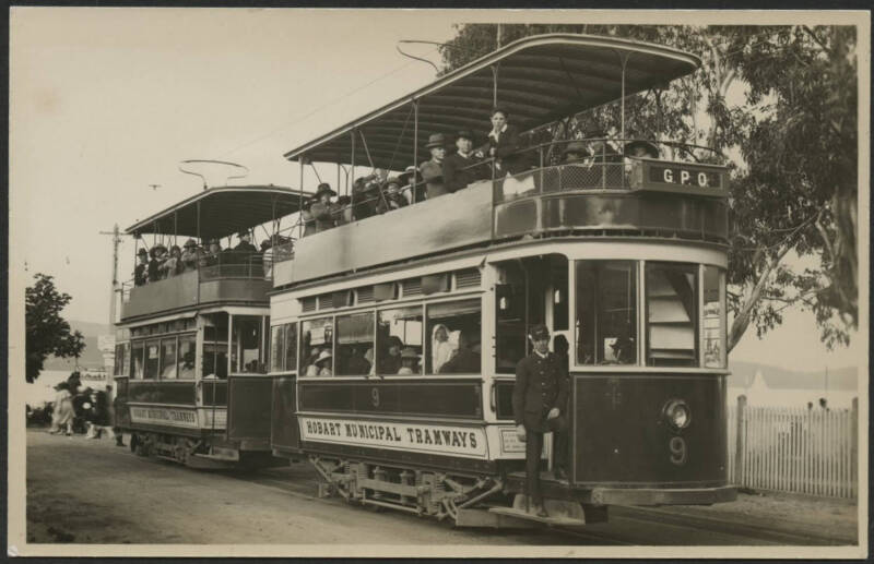 Tasmania: Hobart: ‘Hobart Municipal Tramways’ real photo card showing two electrified double-decker trams (#8 & #9) fully laden with passengers & driver in uniform standing on running board, unused, fine condition.