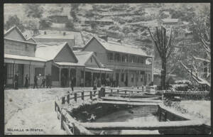 Victoria: Walhalla: ‘Walhalla in Winter’ postcard (produced by Lee Bros, Stationers, Walhalla) showing snow-covered Walhalla Road & Creek with Hotel, Bakery, locals standing under verandahs and township in background, unused, couple of minor blemishes.