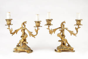 A pair of gilt bronze cherub and foliate form twin branch table lights, French 19th century