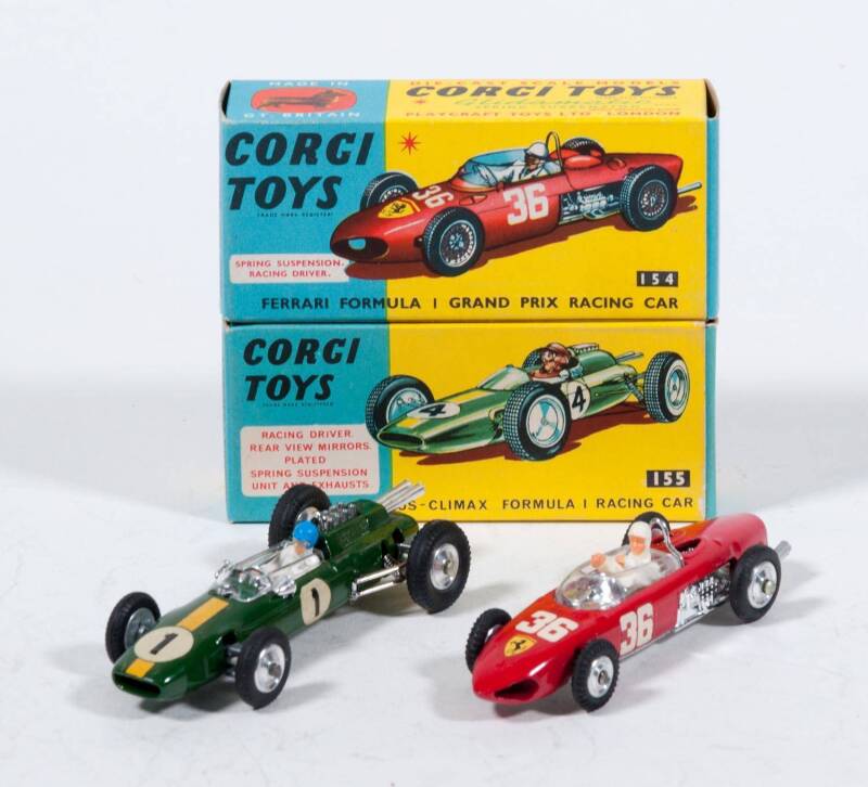 CORGI: 1960s pair of Formula 1 Racing Cars consisting of Ferrari Formula 1 Grand Prix Racing Car (154) – Red with Driving Figure; and, Lotus-Climax Formula 1 Racing Car (155) – Green with Driving Figure. Both mint in original yellow and blue cardboard box