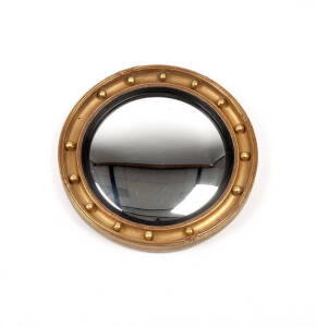 A small gilt wood convex wall mirror in the English Regency style