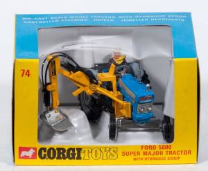CORGI: Late 1960s to early 1970s Ford 5000 Super Major Tractor with hydraulic scoop (74) – Blue with Yellow Scoop and Plastic Driver Figure. Mint in original yellow and blue windowed box with original Plastic packing pieces.