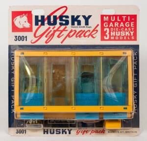 HUSKY (CORGI JUNIOR): Late 1960s Multi-Garage (3001) – Yellow and Blue Plastic with Three Models Consisting of Containing Skip Lorry, Road Roller and shovel. Mint in original unopened blue, white and red blister pack. 