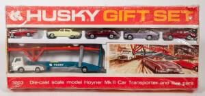 HUSKY (CORGI JUNIOR): Late 1960s Transporter Gift Set (3003) – set comprising of Jaguar E-type - Maroon, Jaguar 3.4 litre - lemon, Aston Martin - Metallic Mauve, Ferrari Berlinetta – Red, Sunbeam Alpine – Red with Blue Hood and Ford Car Transporter - Oran