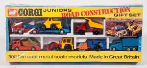 CORGI JUNIORS: Early 1970s Road Construction Gift Set (3011) - Set Comprising of Low Loader, JCB, Dumper Truck, Skip Truck, Earth Mover, Roller and Truck. Mint in original yellow and blue cardboard windowed box with original plastic packing tray and still