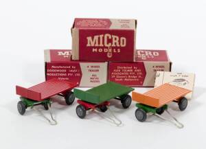 MICRO MODELS (Australia): 1950s Group of 4 Wheel Trailer Consisting of 4 Wheel Trailer (Red with Green Base); And, 4 Wheel Trailer (Green with Red Base); And, 4 Wheel Trailer (Yellow with Green Base). Mint in original maroon and grey cardboard boxes. Dama