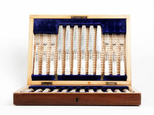 FRUIT CUTLERY SET: Setting for 12 with carved mother of pearl handles & engraved decoration, housed in a fitted plush lined timber box. Early 20th century.