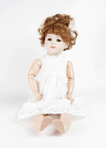 Porcelain headed doll with composition limbs sined "J.Moffat.80. Julla 1914" dressed in a white under gown. 20th century. 65cm