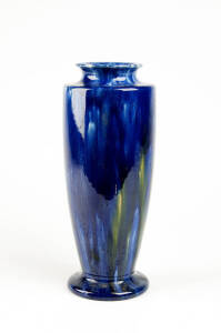 McHUGH: Tasmanian pottery vase glazed in blue with yellow highlights. Incised signature, height 28cm.