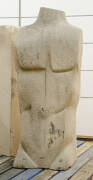 A large carved sandstone torso of a male