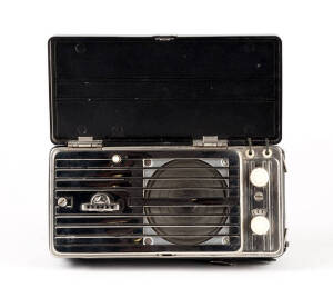 ASTOR: Early portable radio with chrome grill.