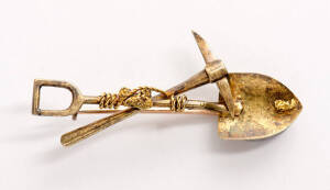 GOLD MINING BROOCH: Crossed pick & shovel mounted with 2 nuggets. Stamped Rand Gold. 6 grams