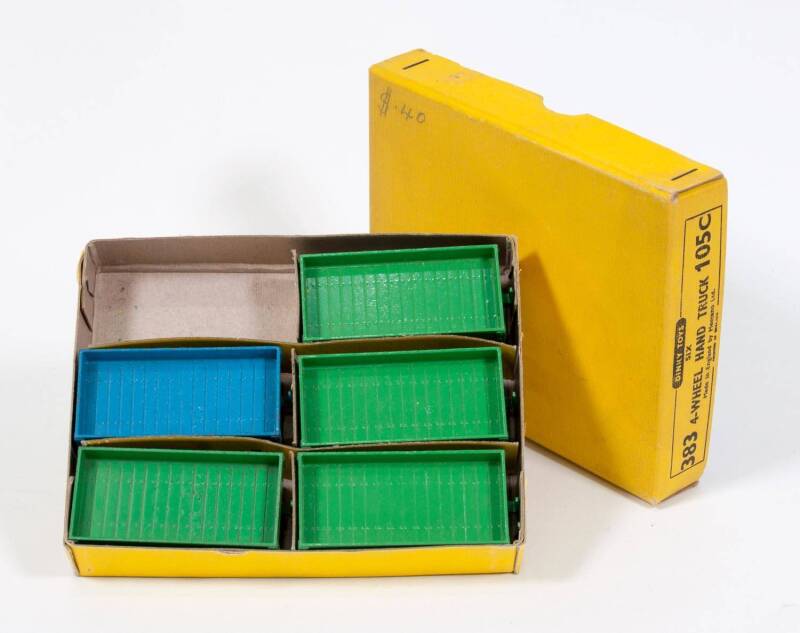 DINKY: 1940s to 1950s 4-wheel Hand Truck Trade Pack of 6 (105C/383) – Contains Four Green with Yellow Hubs and One Blue with Yellow Hubs. Mint to near mint still in superb original trader pack with original dividers. It is missing one hand truck. (5 items