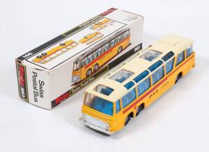 DINKY: Early 1970s Vega Major Swiss Postal Bus (961) – Yellow, Cream Roof, Red Side Stripe, Blue Interior with Cast Hubs. Mint in original black and white cardboard box. Damage to the end flaps of one side of the cardboard box. 