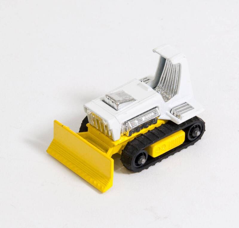 MATCHBOX: 1970s Big Bull Pre-Production Colour Trail (12) – White Body, Yellow Base and Plastic Rollers with Rubber Tracks. Mint and unboxed. 