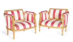 A pair of French 19th Century Bergeres with carved and gilt timber frames, upholsterd in red and gold fabric.&nbsp;