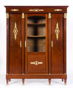 A French three door walnut display bookcase with Ormolu mounts. Early 20th Century.&nbsp;151 x 43 x 183cm