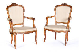 BERGERES: Pair of French carved walnut and beige silk upholsterd armchairs circa 1870's