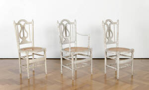Three matching cream painted caned chairs, French early 19th century