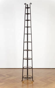 A large cast iron ten tier saucepan stand