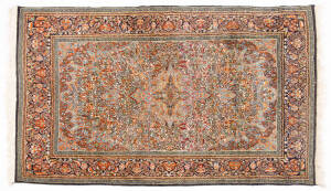 Persian rug: hand knotted floral motif on green background. 188cm x 121cm