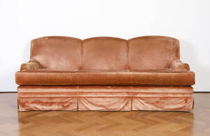 A large three seater settee covered in chestnut brown velvet