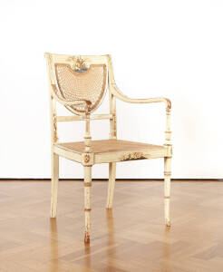 French Chinoiserie cream finished elbow chair with wicker seat and back. Early 19th century.