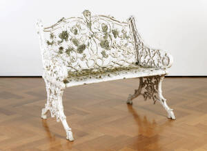 Ornate cast metal garden seat. Width 94cm