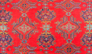 Turkish hand knotted woolen rug. Impressive floral motif and geometric patterned border. Rich blue and red and green tones. 3.3m x3.3m