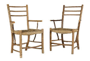 A pair of rush seated branch form armchairs