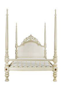 A beige painted four poster bed